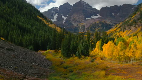 Maroon-Bells-Pyramid-Peak-Aspen-Snowmass-Colorado-wilderness-Incredible-stunning-cinematic-aerial-drone-fall-autumn-colors-snow-covered-Rocky-Mountains-peaks-morning-pan-up-slow-reveal-forward-upward