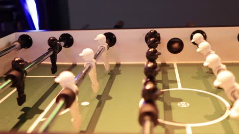 intense foosball match with black and white teams