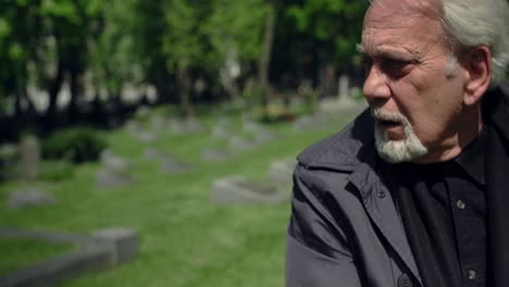 man reflecting in a cemetery