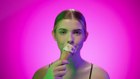 caucasian girl enjoys a cold ice cream cone, tasty sweet dessert, studio shot