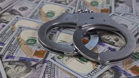 legal justice desk with police handcuffs of many currency cash us dollars