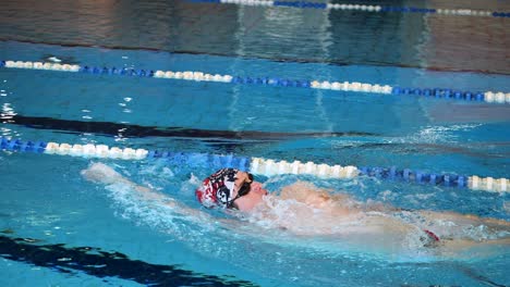 man swimming backstroke