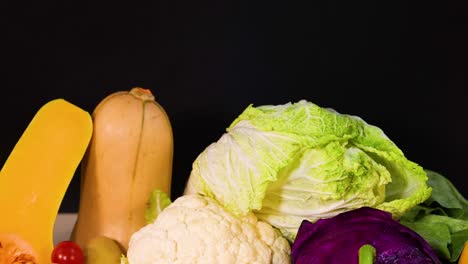 assorted vegetables displayed against a dark backdrop