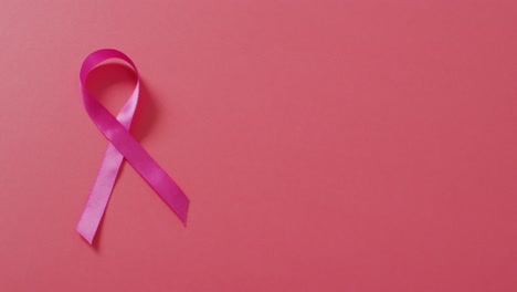 Video-of-pink-breast-cancer-ribbon-on-dark-pink-background
