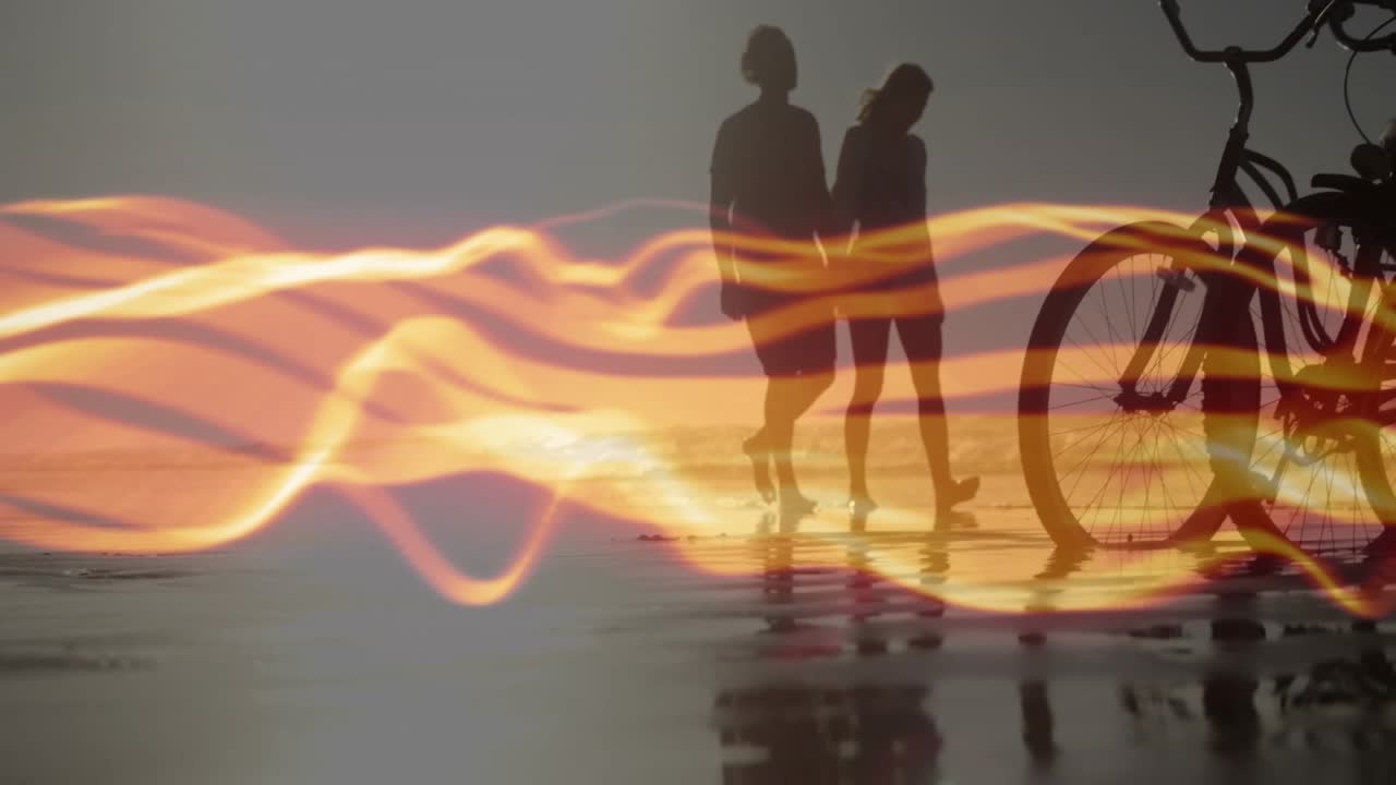 Receding golden light overlay revealing two travel companions walking shoreline with bicycles