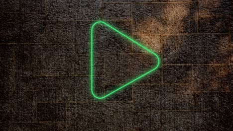 animation of glowing neon play icon on brick wall