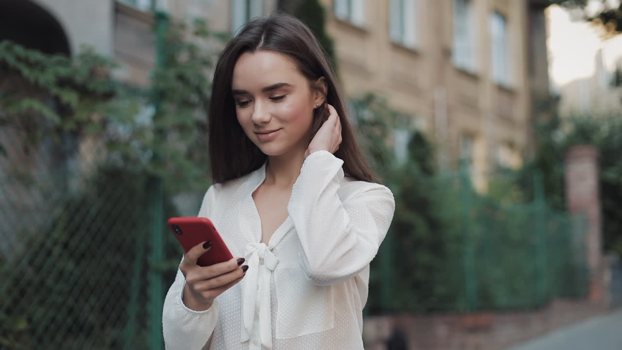 A young woman using her phone outdoors