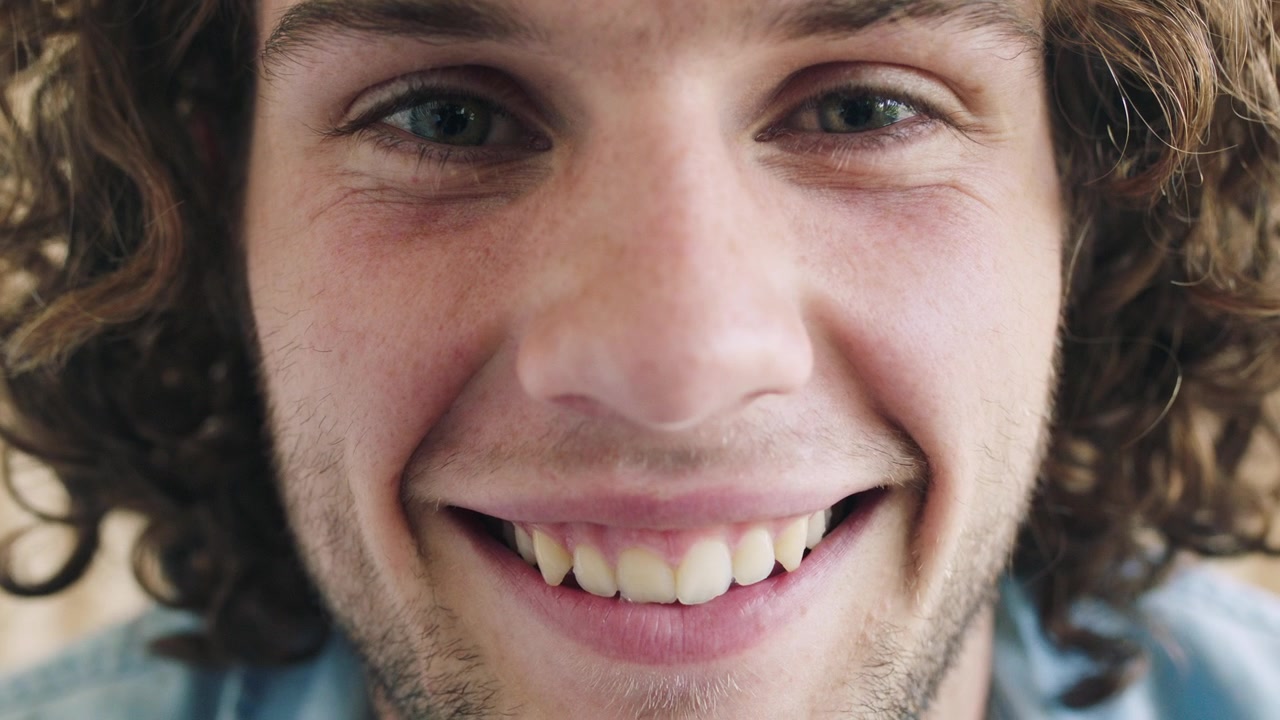 Close-up Portrait of a Young Man Smiling at the Camera