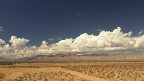 aerial hyper lapse in the mojave desert of storm clouds