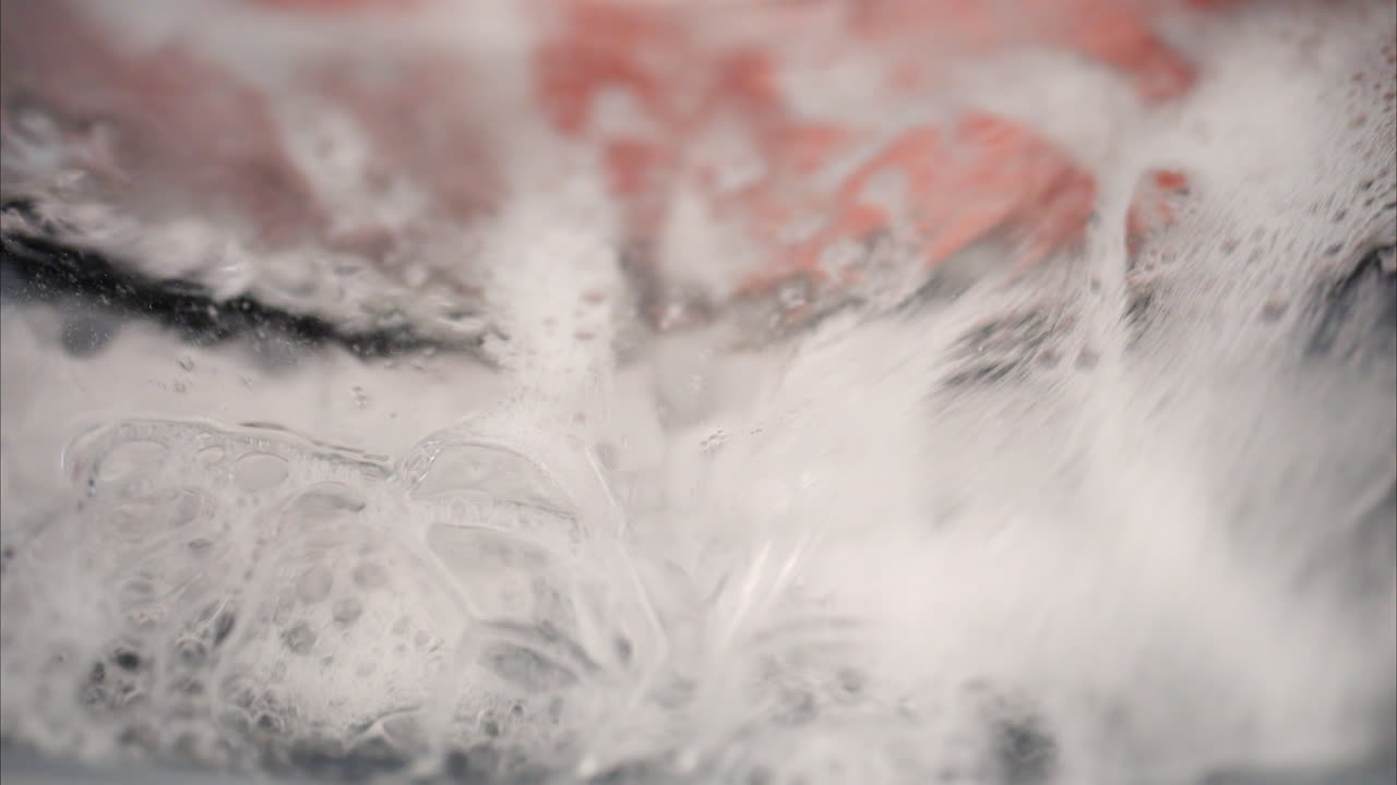 Close up of clothing being laundered in the washing machine