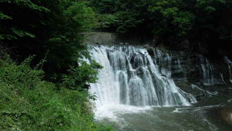 A-waterfall-cascades-in-a-tropical-rainforest-with-rock