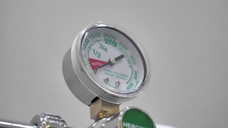 slow motion shot of a colon hydrotherapy pressure gauge showing recommending pressures