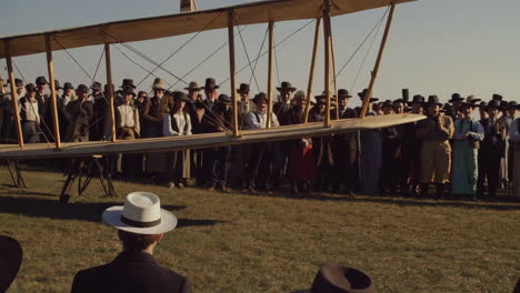 crowd watches a vintage airplane