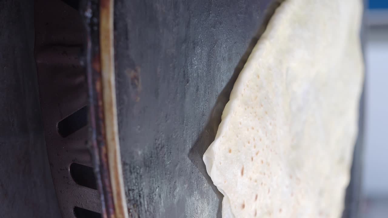 Close-up of flatbread cooking on a hot griddle