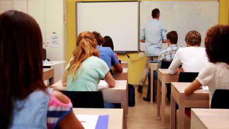 Lecturer-walking-around-his-class-during-an-exam