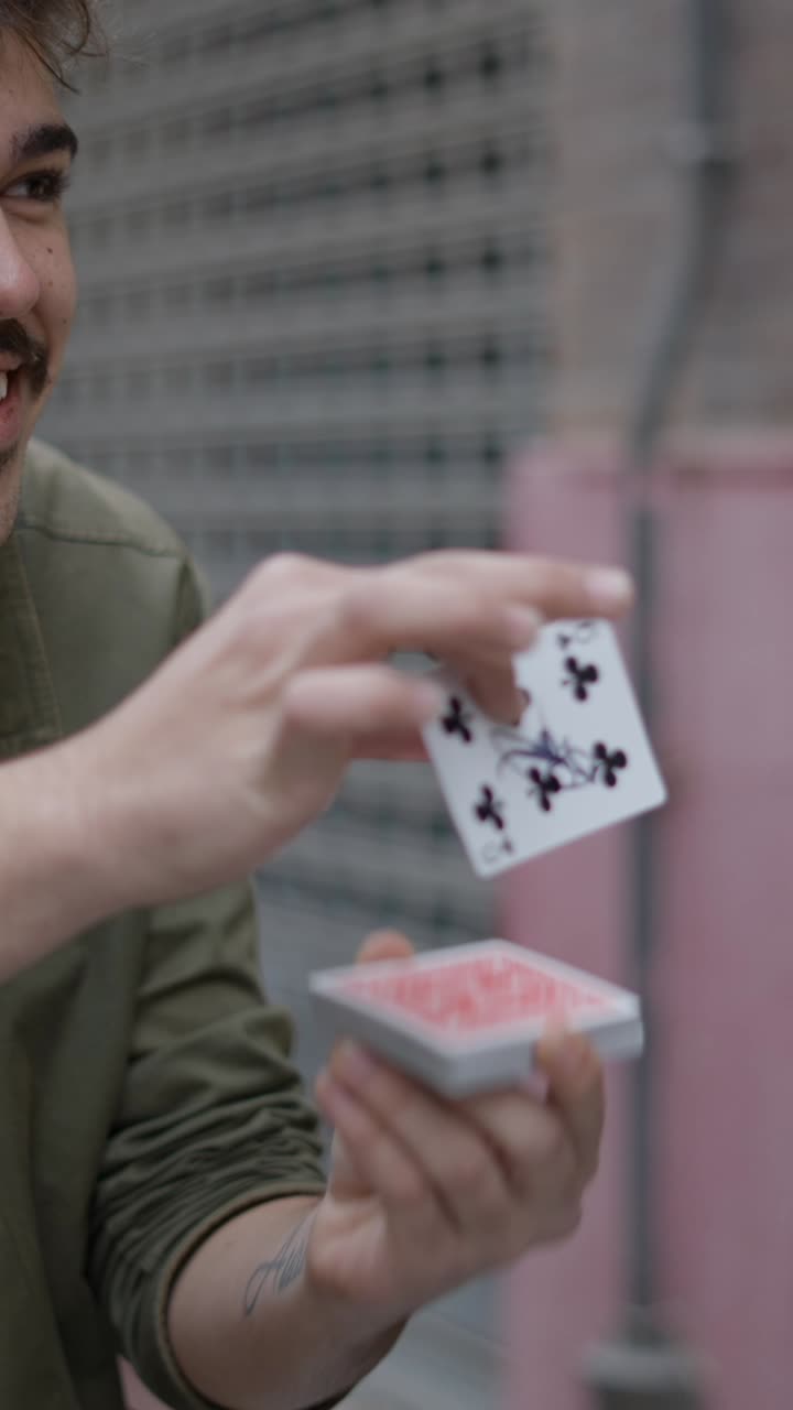 Close-up of Hands Shuffling a Deck of Playing Cards Outdoors