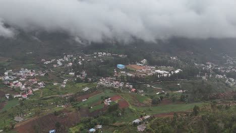 cloud-kissed mountain town seen from a wide-angle drone perspective