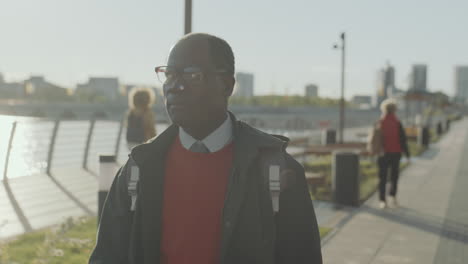 african american businessman walking in city in morning