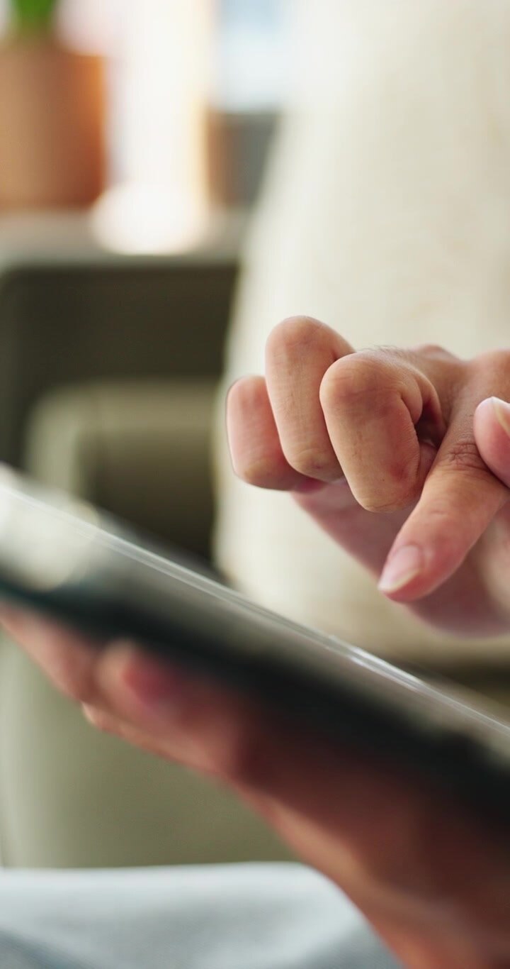 Close-up of Person Using a Tablet Computer