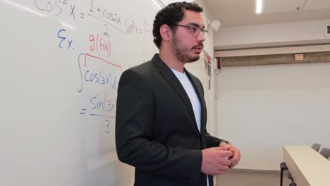 young mentor guiding students through a problem