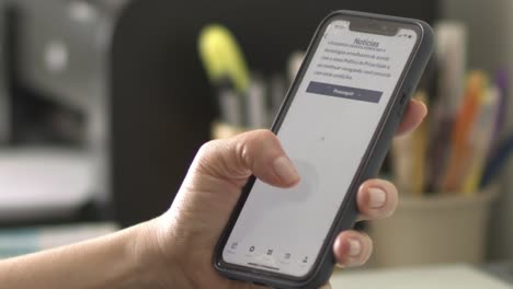 person reading news article on smartphone about plane accident in sao paulo