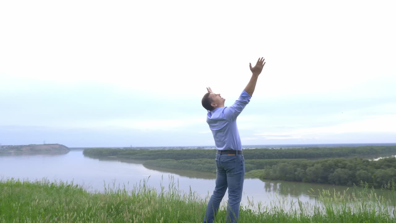 Man with arms outstretched enjoying a view