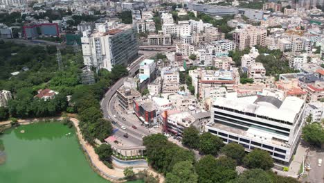 aerial footage of a five-star hotel complex with a swimming pool and trees that looks like a resort in the middle of the city