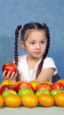 child eating healthy food. beautiful little girl with vegetables on a white background