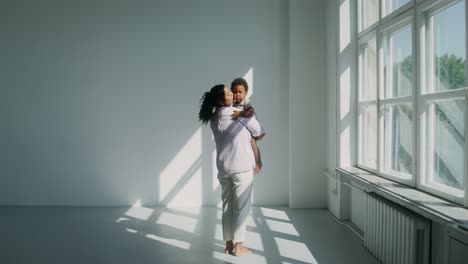 mother and child embracing in sunny room