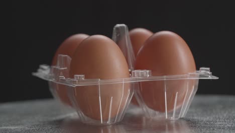 lots of chicken eggs in the cells egg storage box rotating in a slow movement