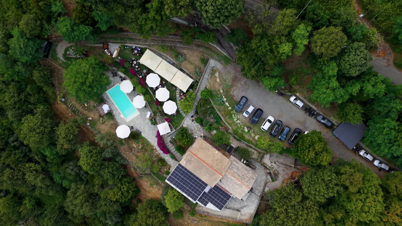 Luxury Event Resort in Woodland Setting, Aerial Drone Shot with cars, parking around lush green forest