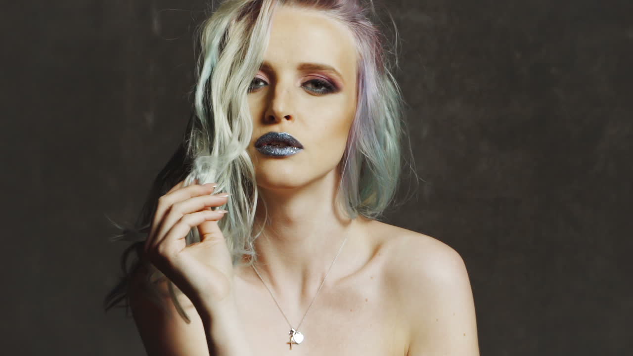 Beautiful girl with colored hair. Colored hairs. Portrait of smiling woman with color hairs. Gradient