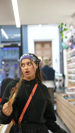 woman shopping and holding fan in store