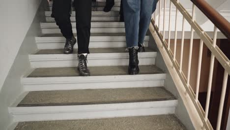 fashionably dressed young people are walking down the stairs