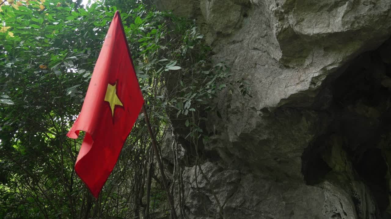 Military hospital cave Cat Ba Vietnam country flag yellow star red background