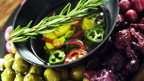 olives, rosemary and chopped pepper in olive oil