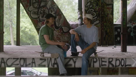 caucasian skateboarders in a ruined building.