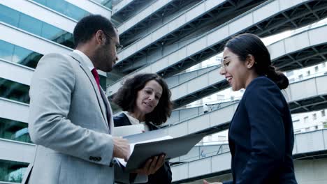 Happy-business-people-discussing-papers