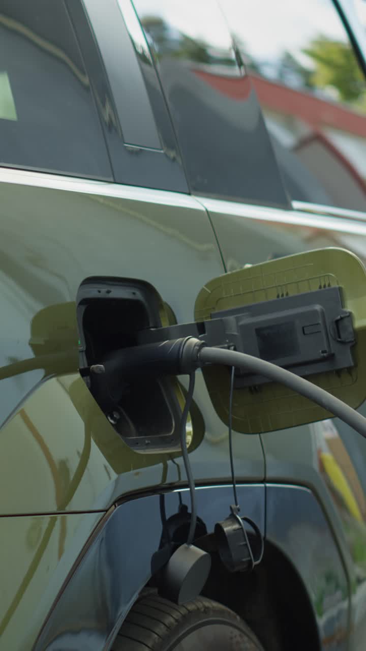 Vertical video Close up of electric car recharging, concept of transition to zero emissions