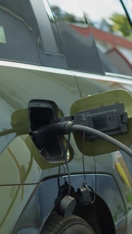 vertical video close up of electric car recharging, concept of transition to zero emissions