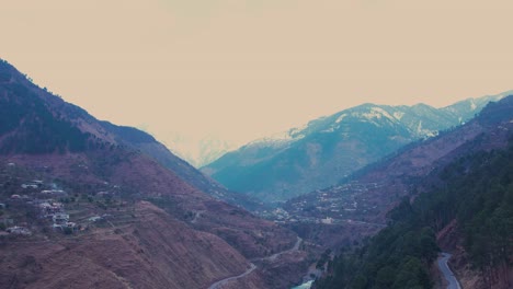 serene-Kishan-Ganga-river-in-Dist-Muzaffarabad,-Azad-Kashmir,-framed-by-snow-capped-mountains