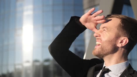 office worker looks at the sky near the business center office worker looks at the sky near the business center portrait of successful businessman in formal clothes young entrepreneur the concept of career growth
