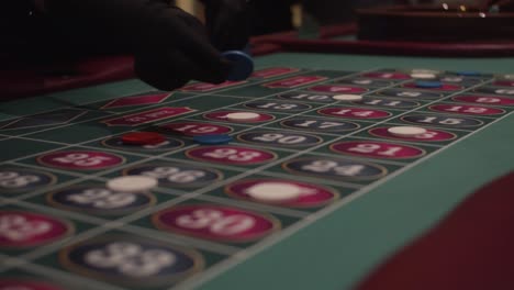 people placing bets on roulette table with chips in slow motion