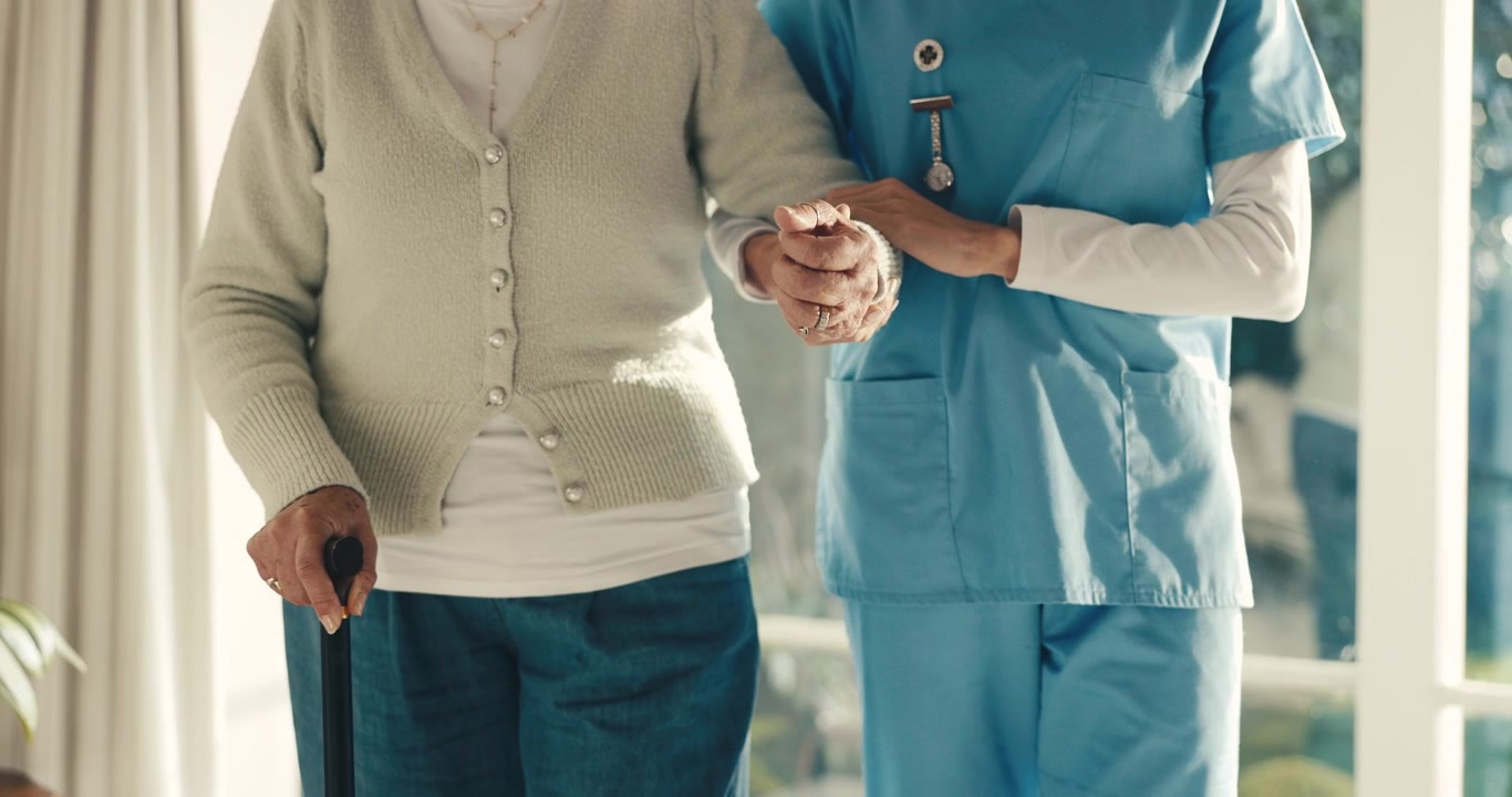 Caregiver Assisting Senior Woman Walking with Cane