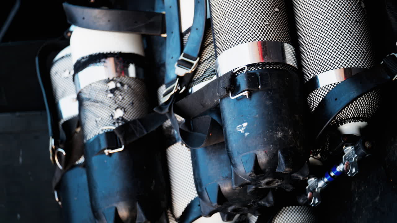 Close up of multiple blue and gray air tanks on a boat. Vertical