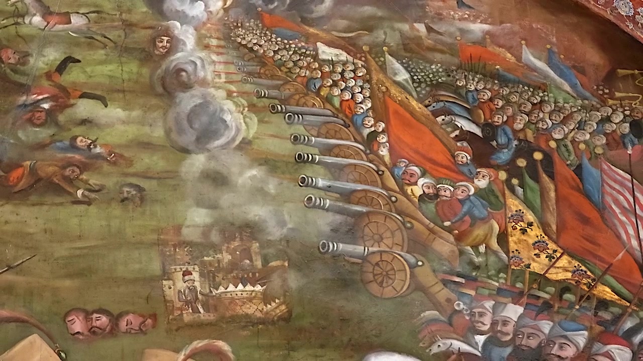 Historical Mural Depicting an Ancient Battle Scene with Cannons