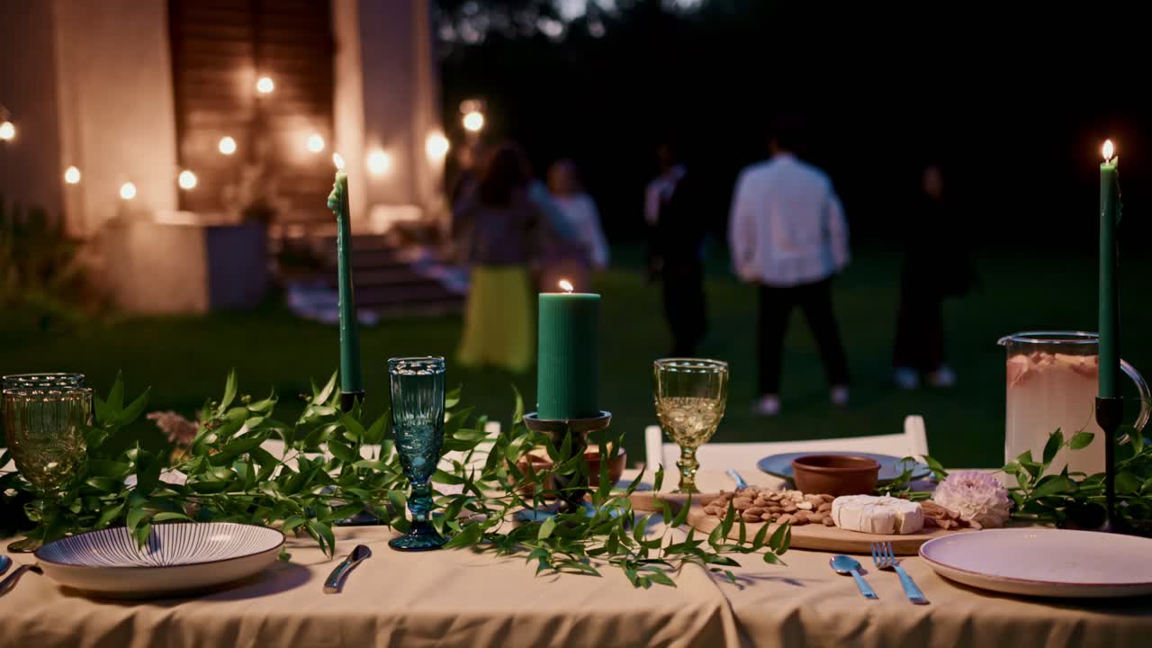 Outdoor Dinner Party with Candles and Friends