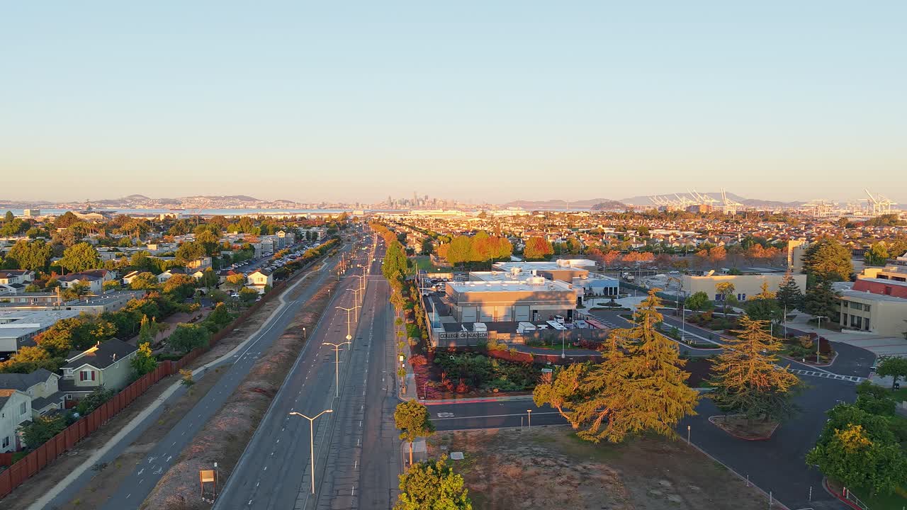 A smooth aerial pass displays Atlantic Avenue's lively activity, blending community life, commercial spaces, and Alameda’s recognizable island atmosphere