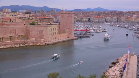 boats enter and exit the harbor in marseilles france 1