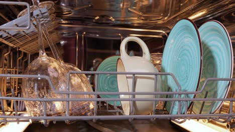 open dishwasher with clean dishes. housekeeping concept.